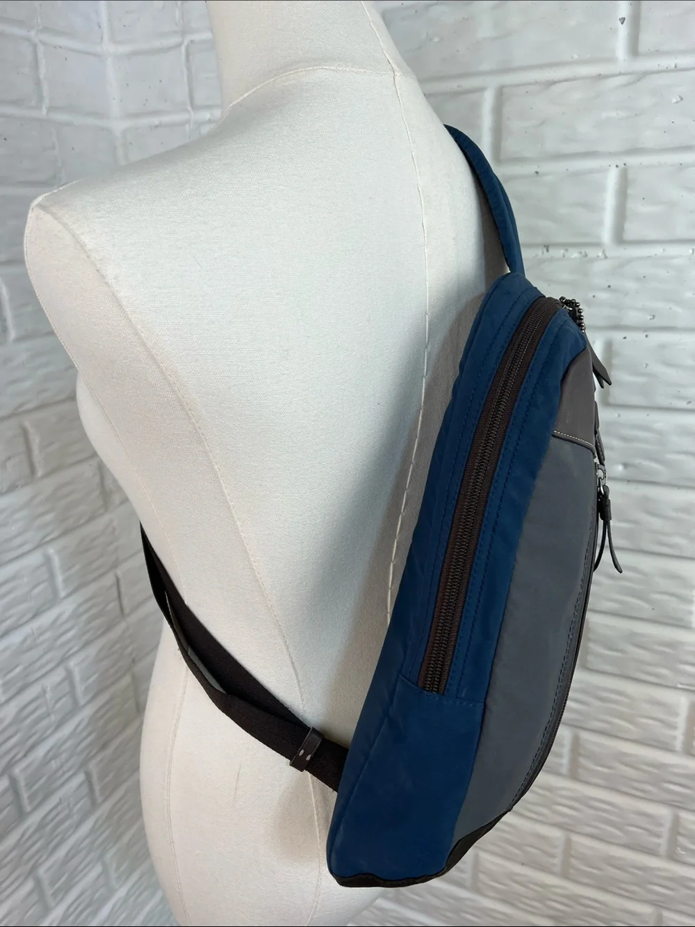 COACH Varick sling bag in navy blue / gray nylon with brown leather trim